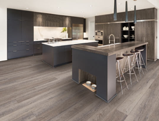 This kitchen is completely updated with an expert installation of luxury vinyl plank in a driftwood look.