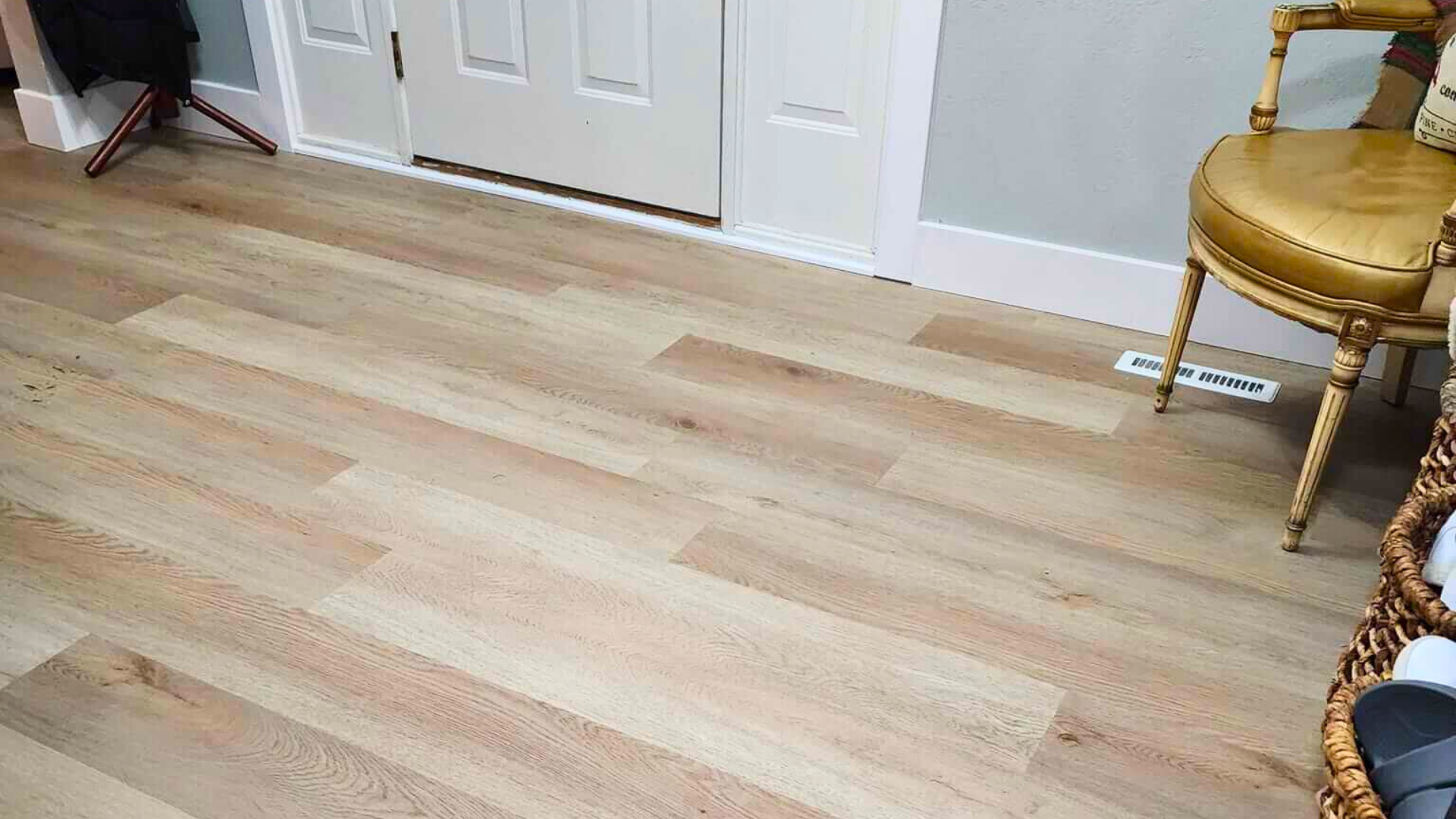 A living space with beautiful, durable, luxury vinyl plank in a light natural wood look.