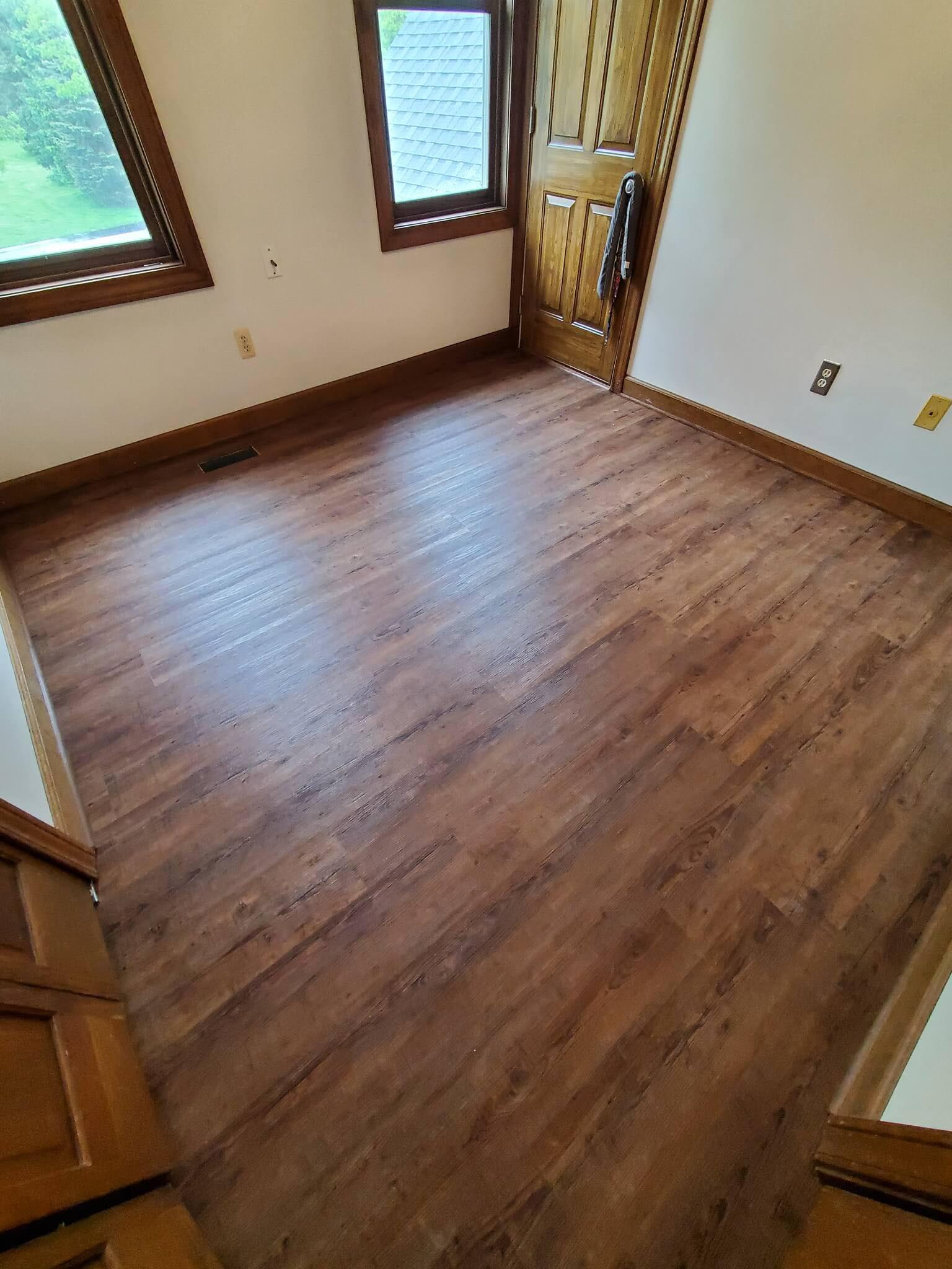 LVP is available in darker wood looks. This room showcases an expertly installed luxury vinyl plank floor in rich earth tones.