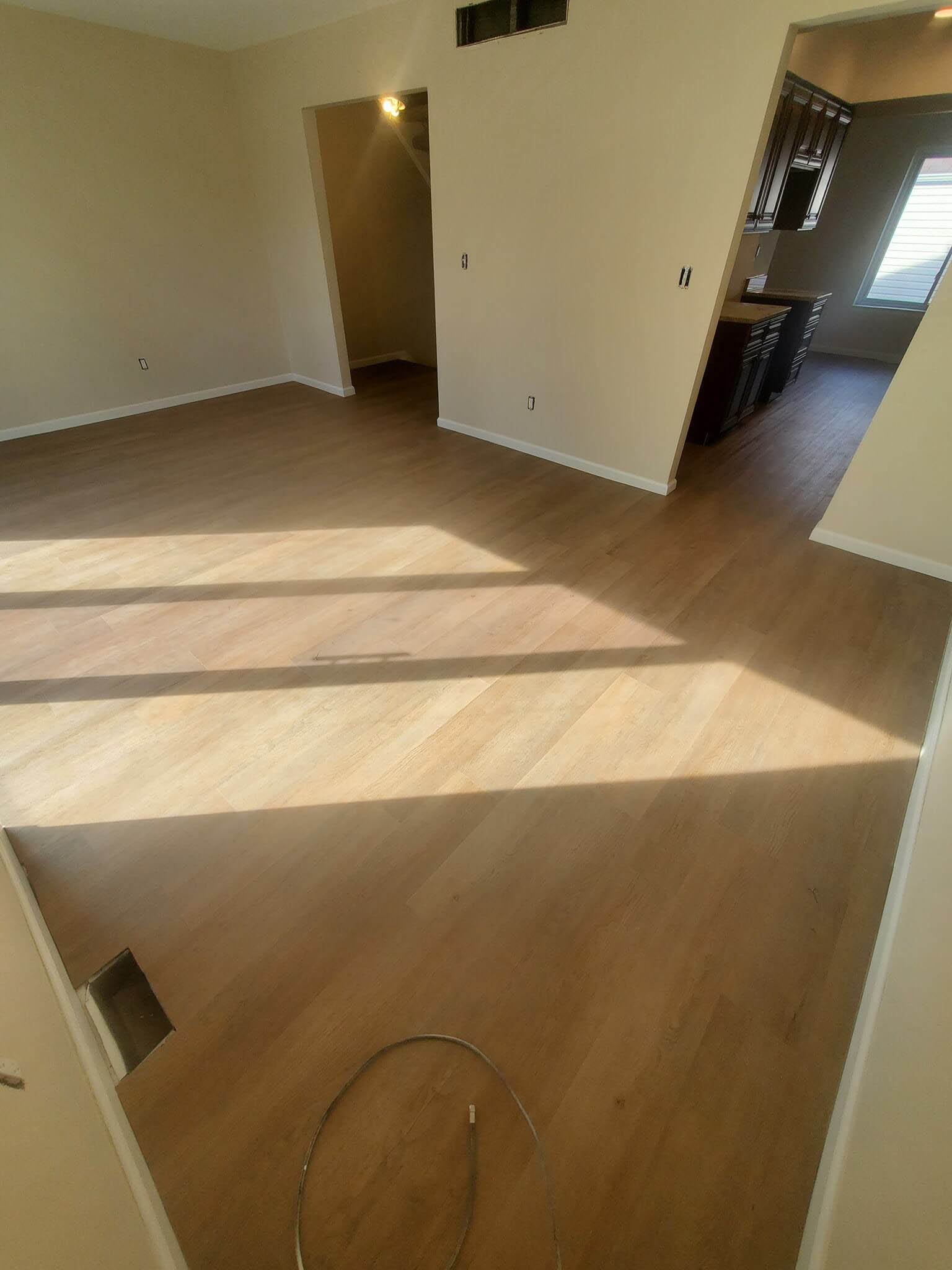 Waterproof luxury vinyl plank flooring is an incredible choice for common areas in your home. This living space is brighter and more beautiful with this expert installation of luxury vinyl plank.