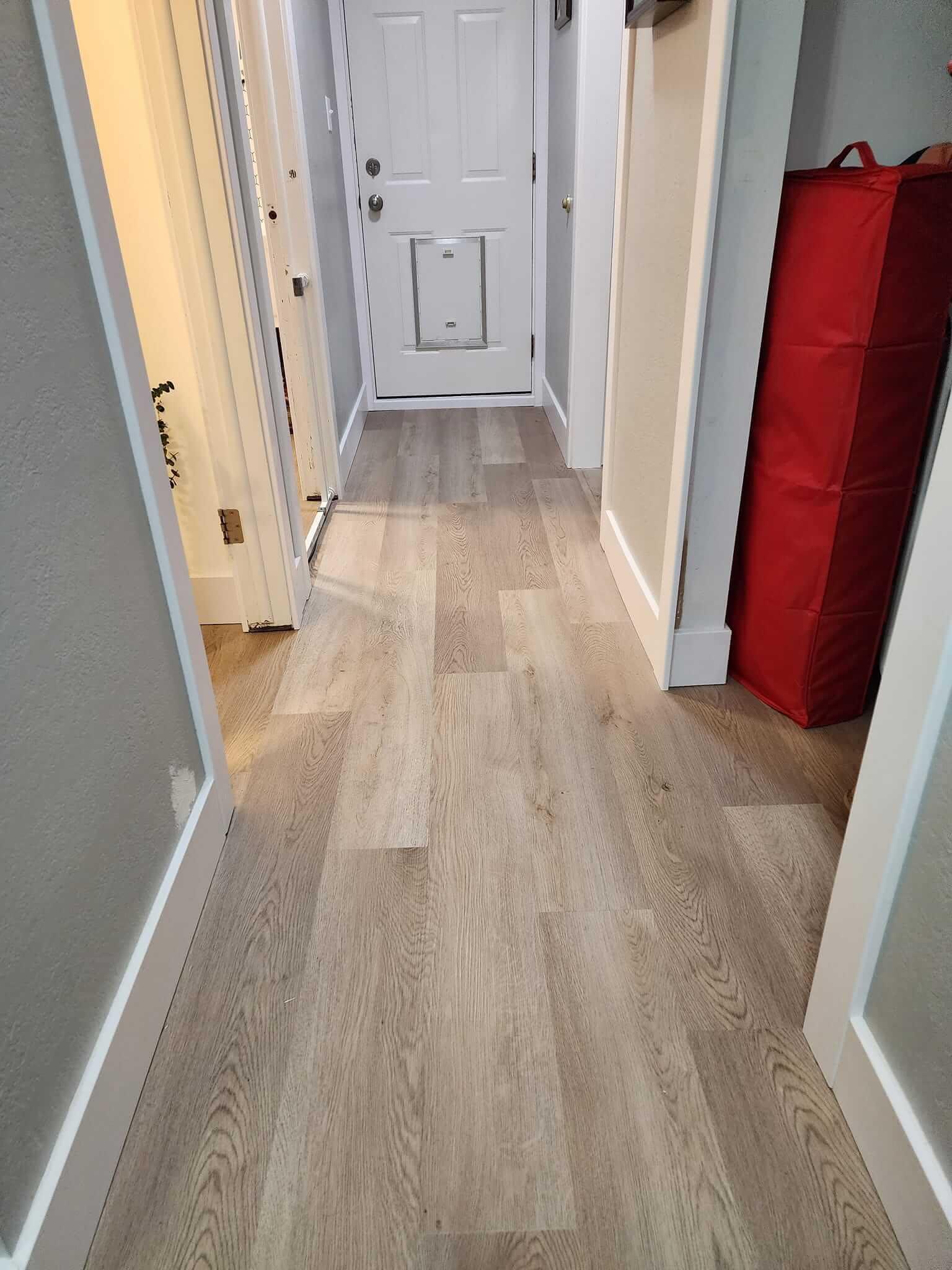 Appropriate stagger patterns are one of the benefits of expert installation. This hall is a gorgeous example of properly installed luxury vinyl plank.