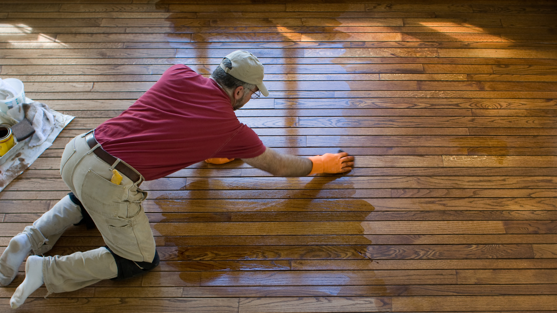 Worker refinishing hardwood floors in Flint MI